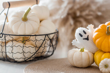 Autumn decor for Halloween. Cute ghost and pumpkins. Banner, background for Halloween celebration.