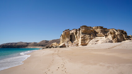 Ras Al-Jinz beautiful beach with cliffs and clear sea water, Oman