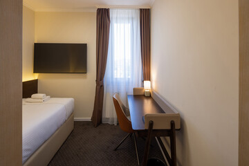 Interior of a hotel room with a master bed in the morning