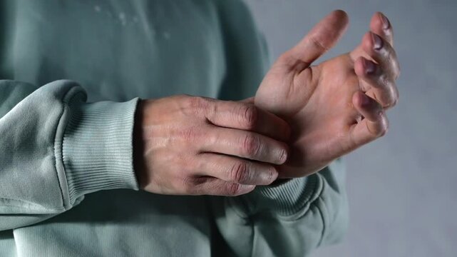 A man scratches his palm.
An itchy palm could be due to an allergy or an insect bite.
A man's palm, close-up.