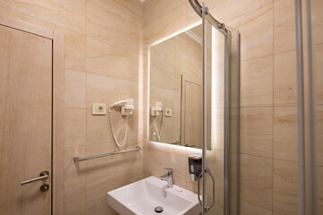 Interior of a hotel bathroom with glass bathroom
