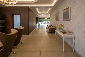 Luxurious interior of a hotel lobby with a polished marble front desk