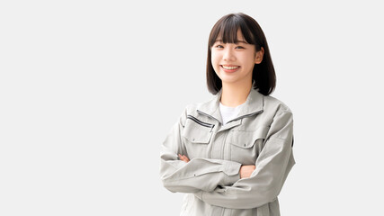 作業服を着て腕組みをする若い女性