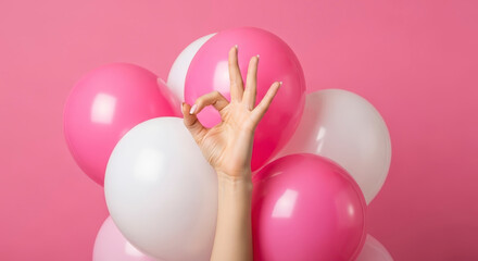 Woman Hand Showing OK Gesture Surrounded by Pink and White Balloons