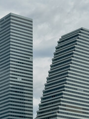 Fototapeta premium Modern Twin Skyscrapers Architecture Cloudy Sky
