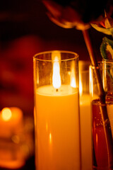 Row of warm yellow LED candles in candle holders for event decor in the dark
