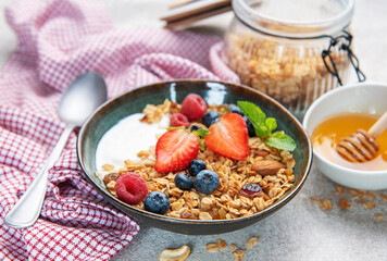 Granola yogurt parfait with fresh berries and honey