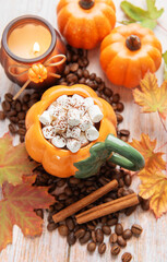 Pumpkin shaped mug with hot chocolate and marshmallows
