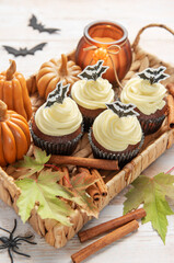 Halloween cupcakes with bat decoration and autumn elements