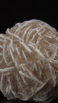 Desert Rose - Baryte (barium sulphate) c2cm across, rotating slowly against a black background. Vertical