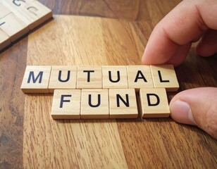 hand placing wooden scrabble-like tiles spelling out -MUTUAL FUND