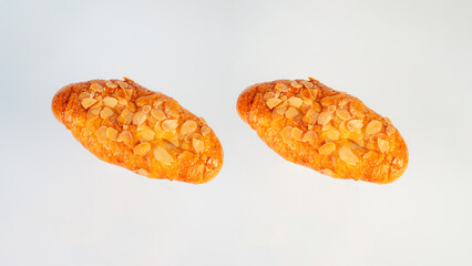 Fresh Rose Croissant with Almonds on White Background