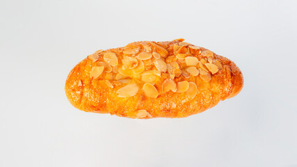 Fresh Rose Croissant with Almonds on White Background