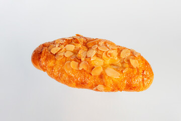 Fresh Rose Croissant with Almonds on White Background