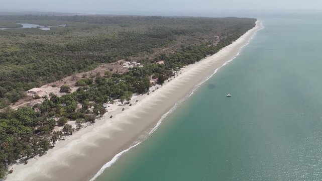 Aerial high angle wide view of Long white sand beach stretching along turquoise sea in the Bijagos Islands, West Africa.