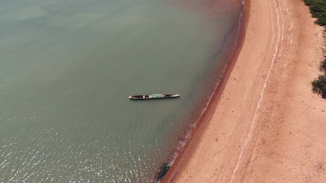Aerial drone view of Pink Sand Beach in Bijag&oacute;s Islands, Guinea-Bissau, showcasing stunning shoreline with turquoise waters and untouched tropical paradise