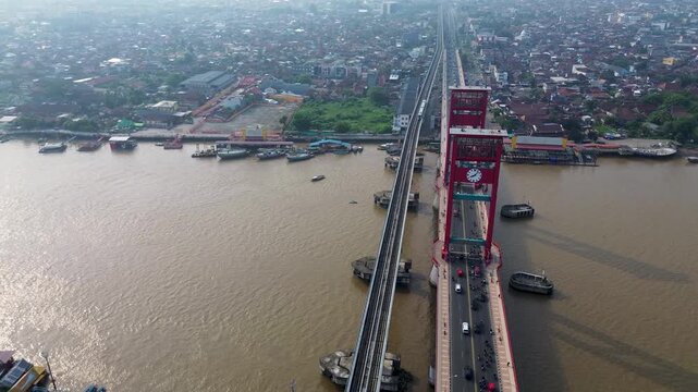 Beautiful Drone Palembang Iconic Ampera Bridge with Train and Cars Crossing at Musi River at day busy transportation