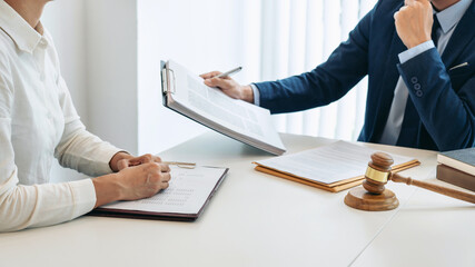Male lawyer and professional businesswoman working and discussion having at law firm in office, Judge gavel with scales of justice