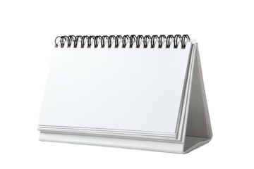 A blank white desktop calendar, spiral bound at the top, sitting on a white table
