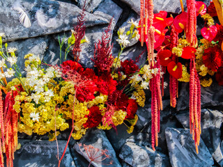 The composition, made up of dried Phalaris and crested celosia, looks great on a dark gray background.