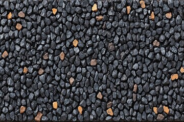 Black pebble texture w/ scattered tan stones. Overhead view