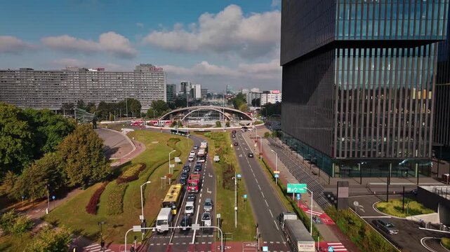 Katowice, Poland - 09 October 2025: Aerial view of Aleja Wojciecha Korfantego, a bustling roundabout with modern architecture and vibrant greenery.