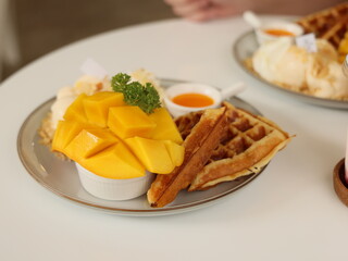 Indulge in a delicious mango dessert that features irresistible waffles and creamy ice cream
