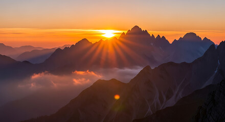 Sunrise over Majestic Mountain Silhouettes with Dramatic Sun Rays