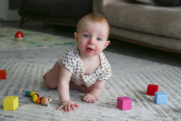 Baby playing on the floor. Copy space, background.