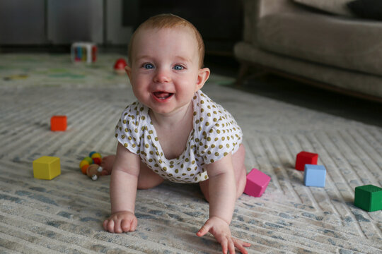 Baby playing on the floor. Copy space, background.