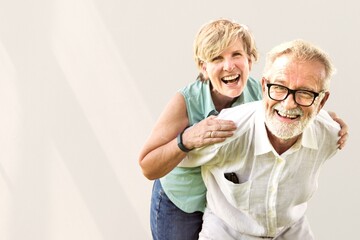 Cute senior couple having piggy back ride