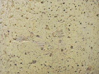 Yellow Porous Stone Wall Background Texture with Small Holes