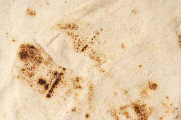 Thin lavash isolated on white background. Armenian unleavened lavash. Lavash as textured bread background.	
