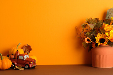 Autumn decor with red truck, pumpkins, and floral vase. Autumn, fall, Thanksgiving concept.
