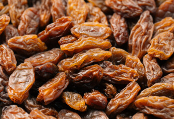 Raisins on a white background. Dried grapes. Background of light-colored raisins.