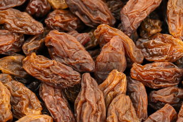 Raisins on a white background. Dried grapes. Background of light-colored raisins.