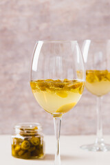 Chili white wine with jalapeno pieces in glasses close up vertical view