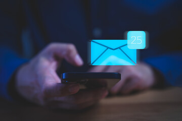 Person checking smartphone with a digital envelope icon notification, representing new email messages, communication technology, inbox management, mobile mail app alerts, and online correspondence.