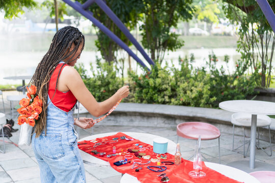 Woman selling handmade jewelry at an outdoor market