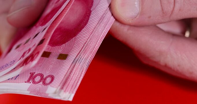 Chinese red money with a face value of 100 yuan, a beautiful background of money used in China close up