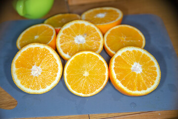 A collection of freshly sliced oranges is resting on a table