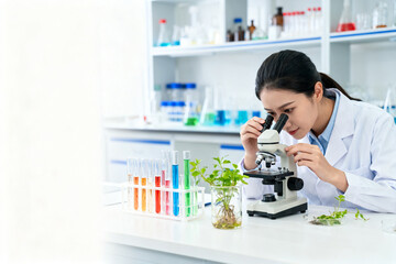 Woman in lab examining plant under microscope
