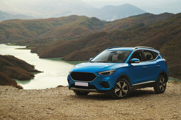 Blue colored suv car on a lake background