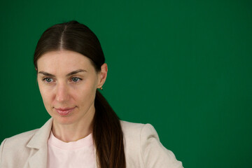 Professional photo collection of young European woman in light blazer with hair tied in ponytail and blue jeans on green chroma key background expressing different emotions and gestures perfect for ad