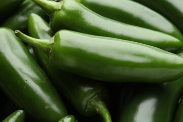 Many green jalapeno peppers as background, closeup