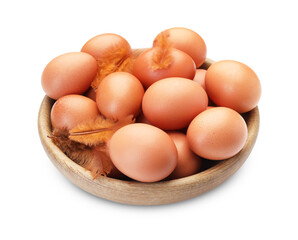 Raw chicken eggs in bowl and feathers isolated on white