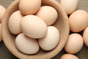 Fresh chicken eggs on wooden table, top view
