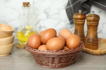 Raw chicken eggs, oil and spices on wooden counter