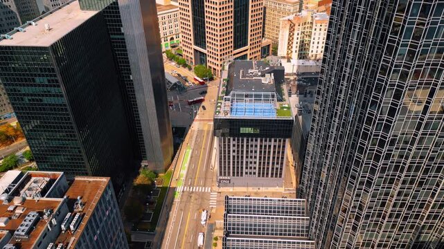 Empty wide-lane street in the downtown of Pittsburgh, Pennsylvania, USA. Drone footage at the fa&ccedil;ade of One PPG Place skyscraper.