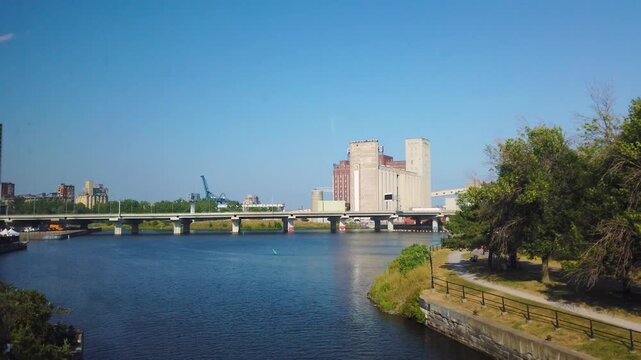 View from the window of a train crossing the water chanal on the bridge and Farine Five Roses flour mill in Montreal, Quebec, Canada.